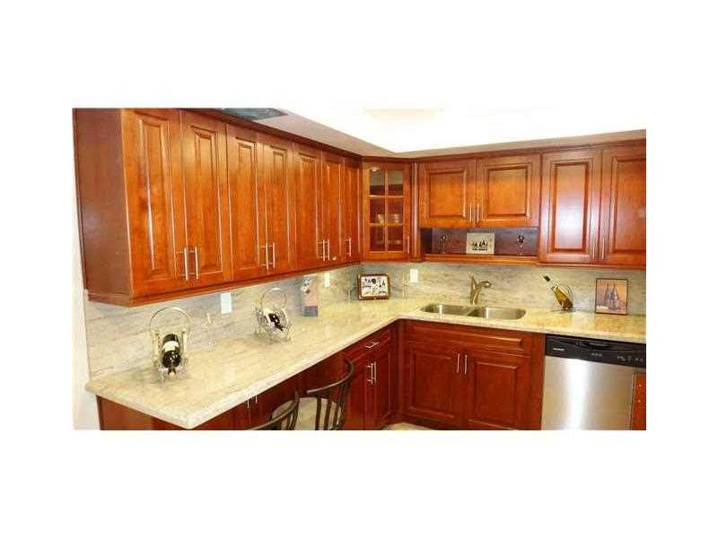 16251 Golf Club Road, Unit 210 Weston, FL 33326 - Photo 25 of 28 a kitchen with a sink and cabinets