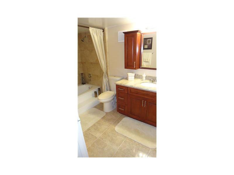 16251 Golf Club Road, Unit 210 Weston, FL 33326 - Photo 27 of 28 a bathroom with a sink and a mirror