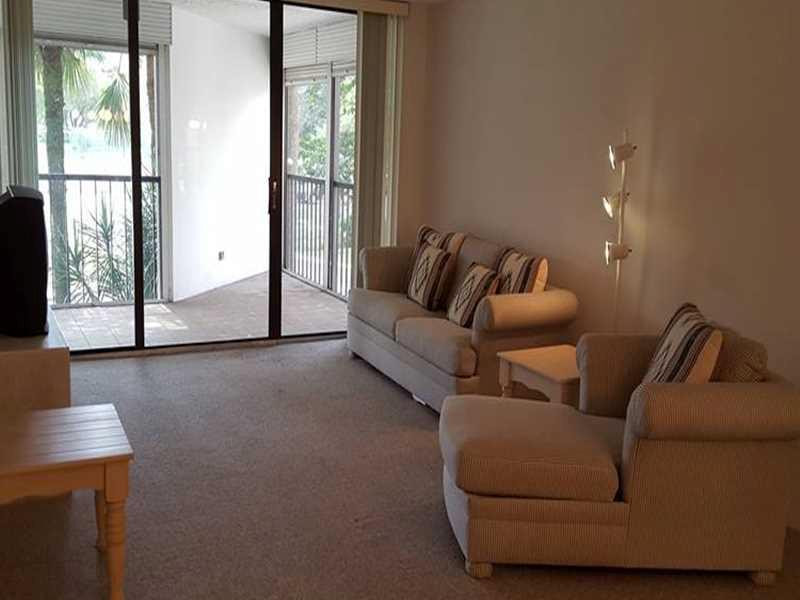 16251 Golf Club Road, Unit 210 Weston, FL 33326 - Photo 3 of 28 a living room with furniture and a large window