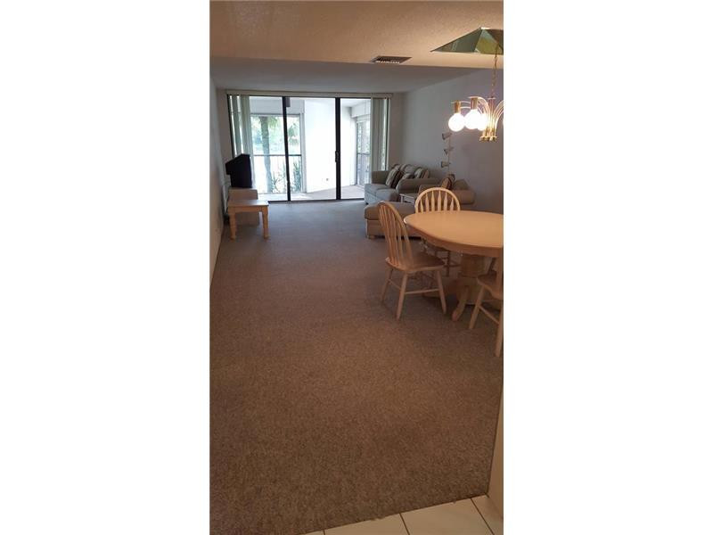 16251 Golf Club Road, Unit 210 Weston, FL 33326 - Photo 5 of 28 a living room with furniture and a window