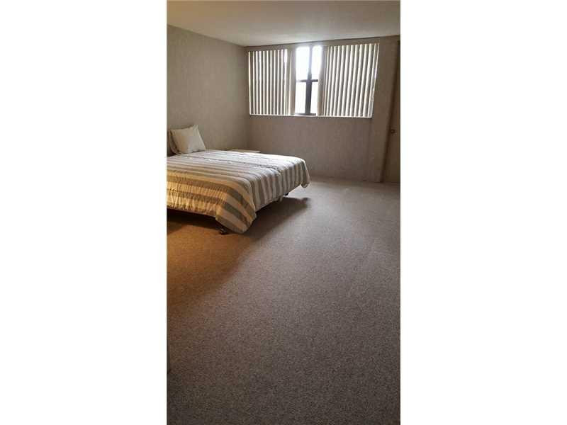 16251 Golf Club Road, Unit 210 Weston, FL 33326 - Photo 6 of 28 a bedroom with a bed and a window