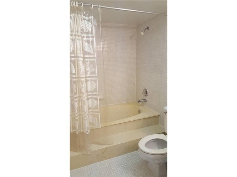 16251 Golf Club Road, Unit 210 Weston, FL 33326 - Photo 8 of 28 a bathroom with a tub shower sink and a toilet