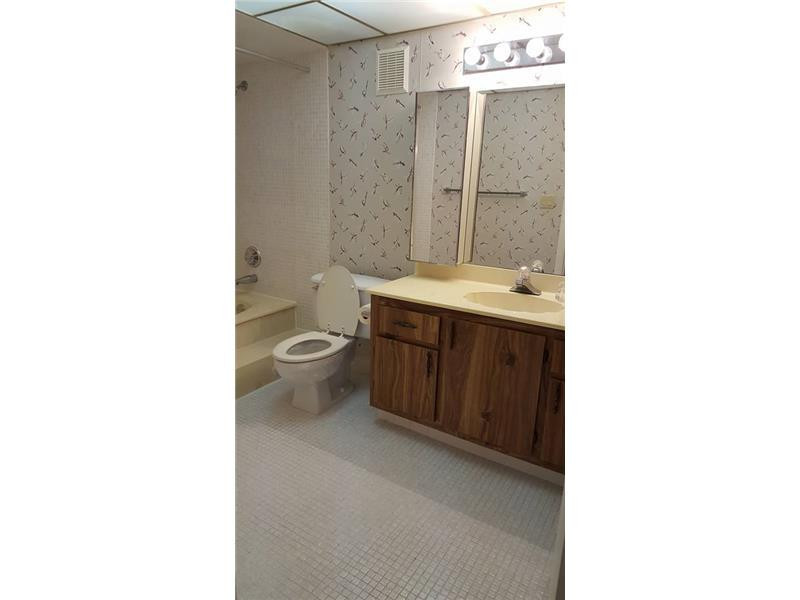 16251 Golf Club Road, Unit 210 Weston, FL 33326 - Photo 9 of 28 a bathroom with a toilet sink and mirror