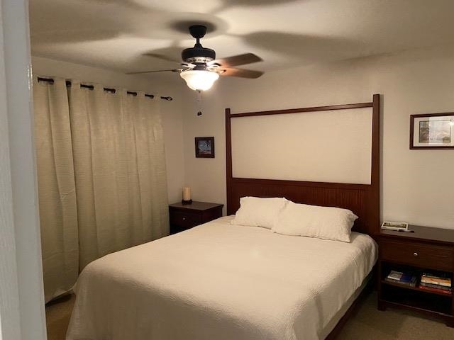 3740 Lower Honoapiilani Road, Unit G205 Lahaina, HI 96761 - Photo 3 of 8 a bedroom with a bed and a chandelier