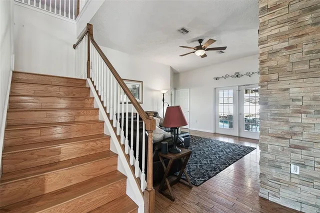 a view of staircase with wooden floor and a window