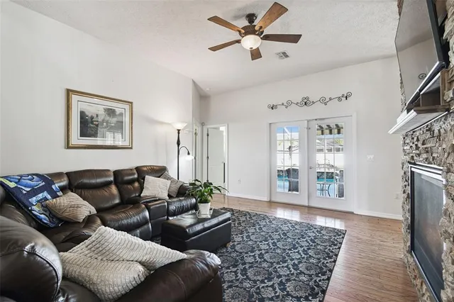 a view of a hallway with wooden floor and windows
