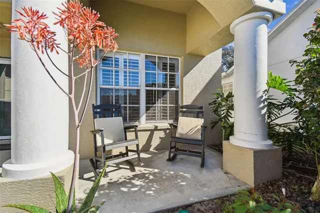 a dining room with furniture a chandelier and wooden floor