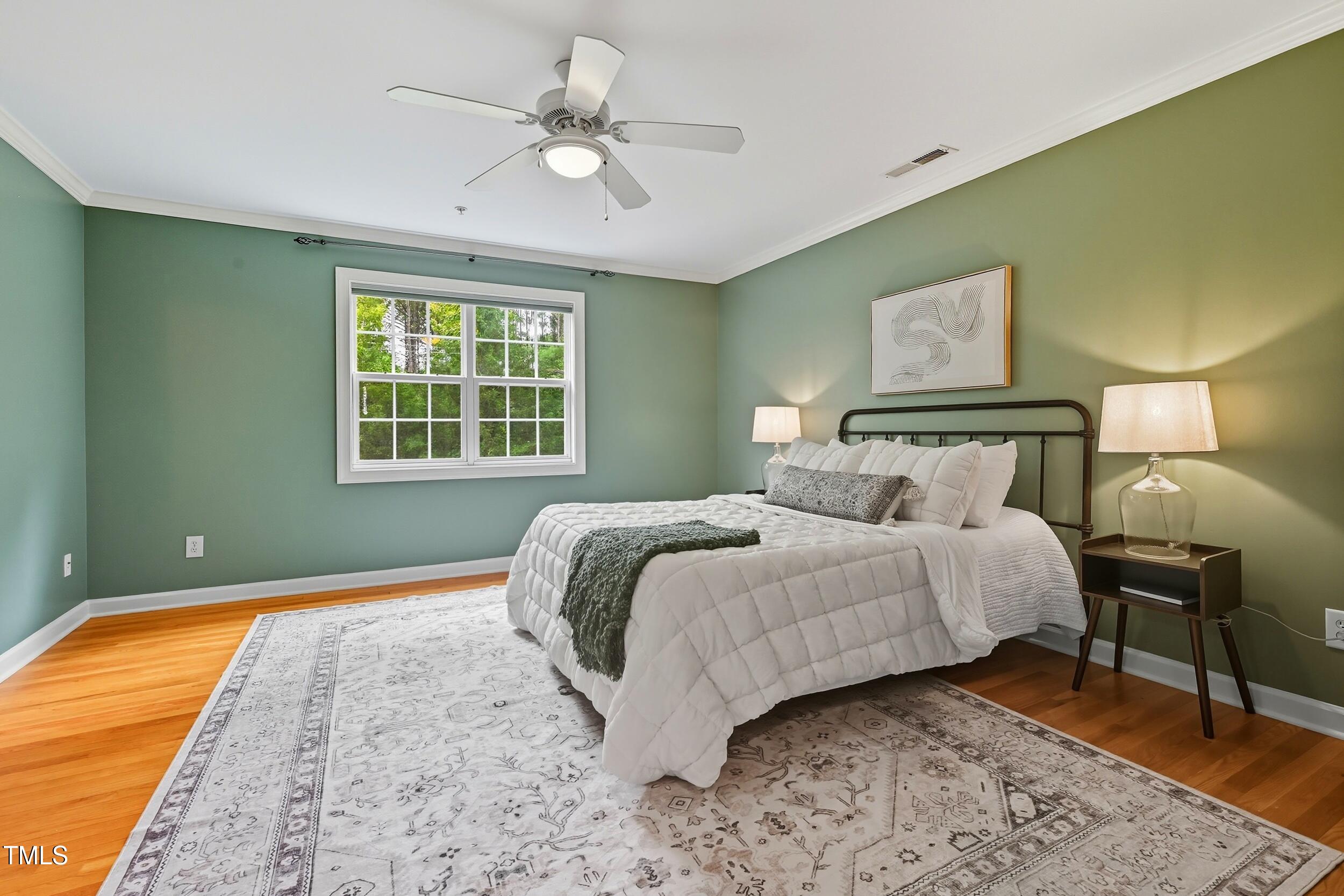 222 Towne Ridge Lane Chapel Hill, NC 27516 - Photo 18 of 39 a bedroom with a bed and a chandelier