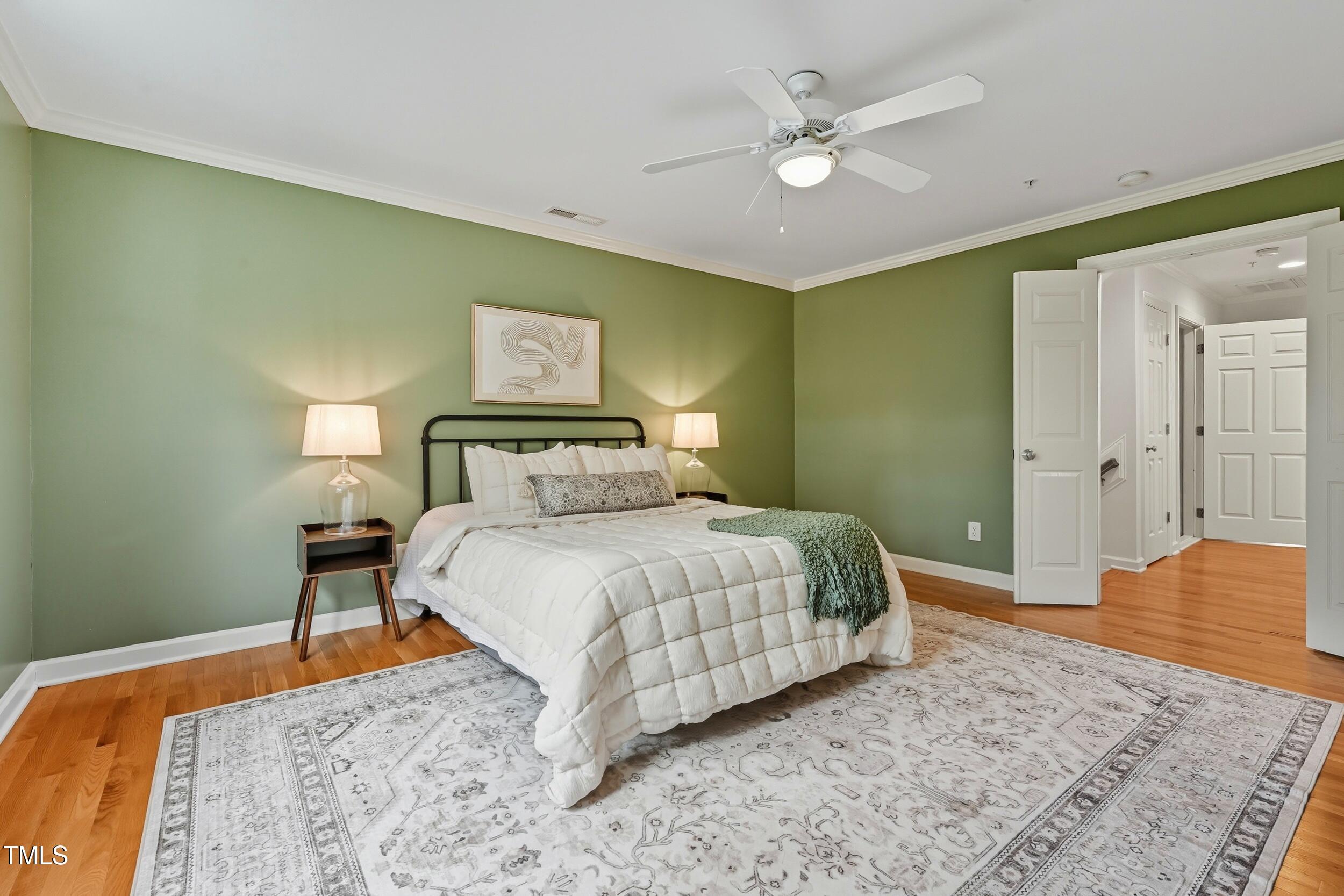 222 Towne Ridge Lane Chapel Hill, NC 27516 - Photo 19 of 39 a bedroom with a bed and a chandelier