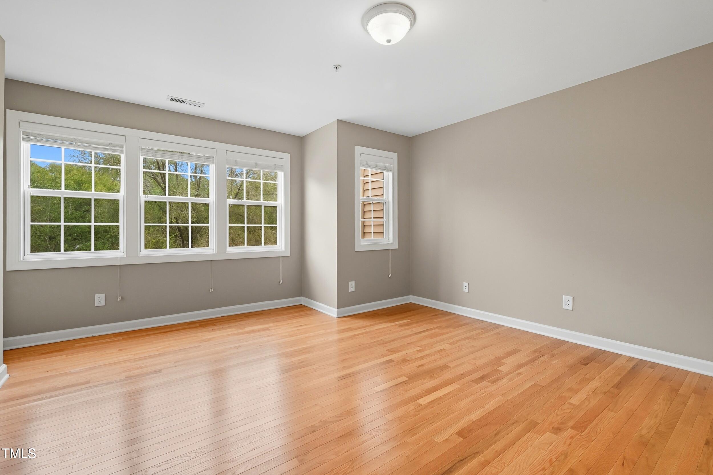222 Towne Ridge Lane Chapel Hill, NC 27516 - Photo 28 of 39 an empty room with wooden floor and windows