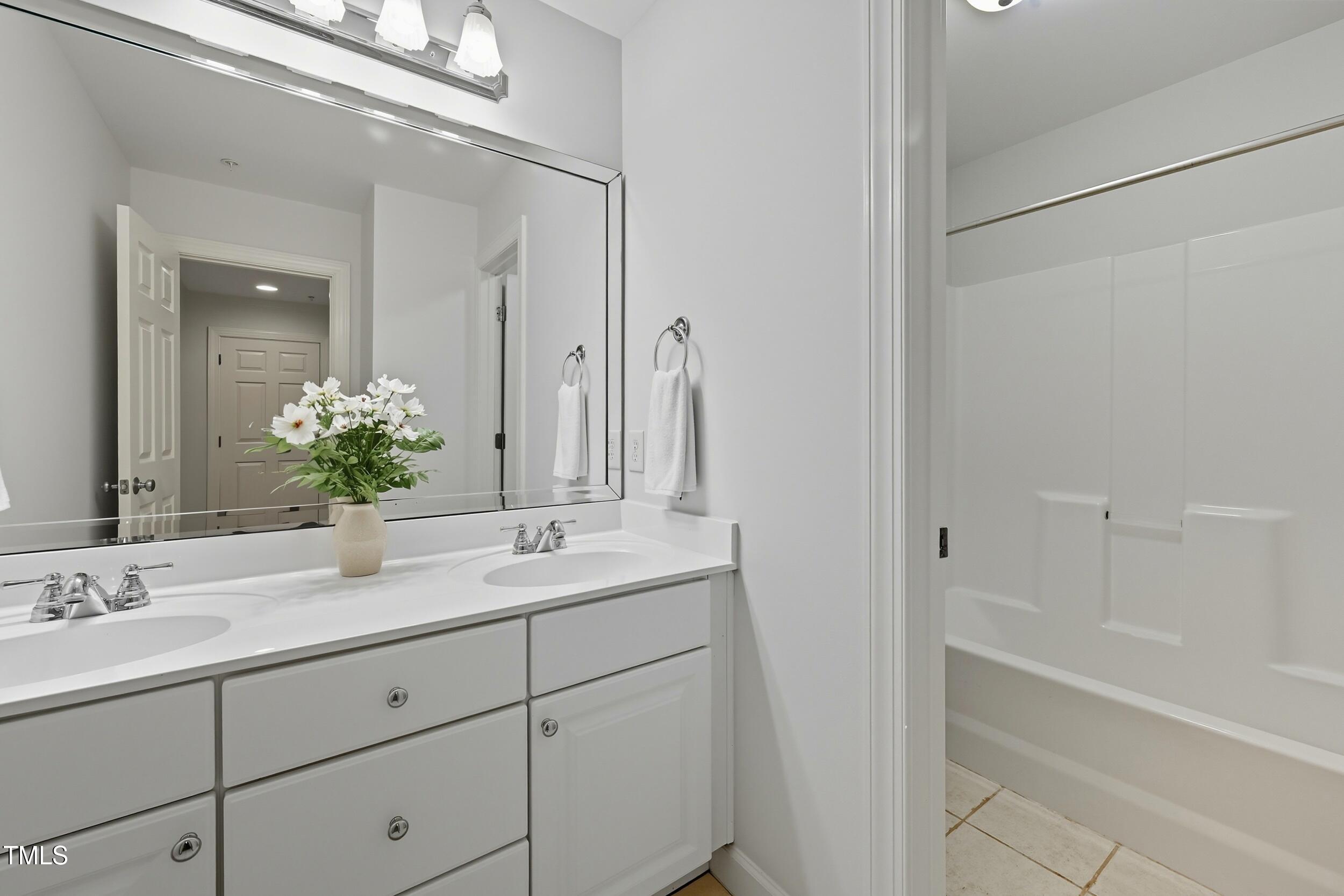 222 Towne Ridge Lane Chapel Hill, NC 27516 - Photo 30 of 39 a bathroom with a double vanity sink and mirror