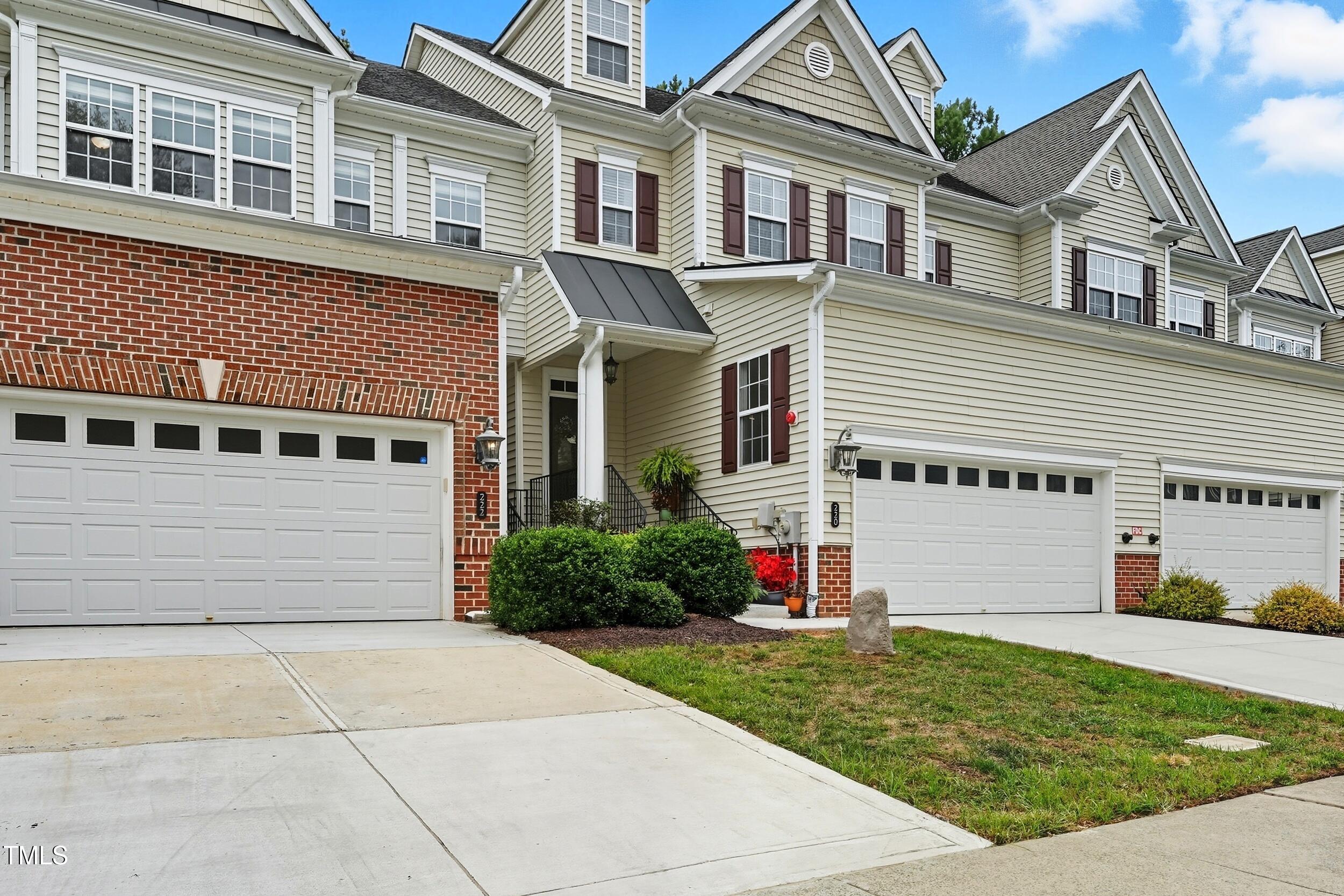 222 Towne Ridge Lane Chapel Hill, NC 27516 - Photo 3 of 39 a view of a white house with a small yard and plants