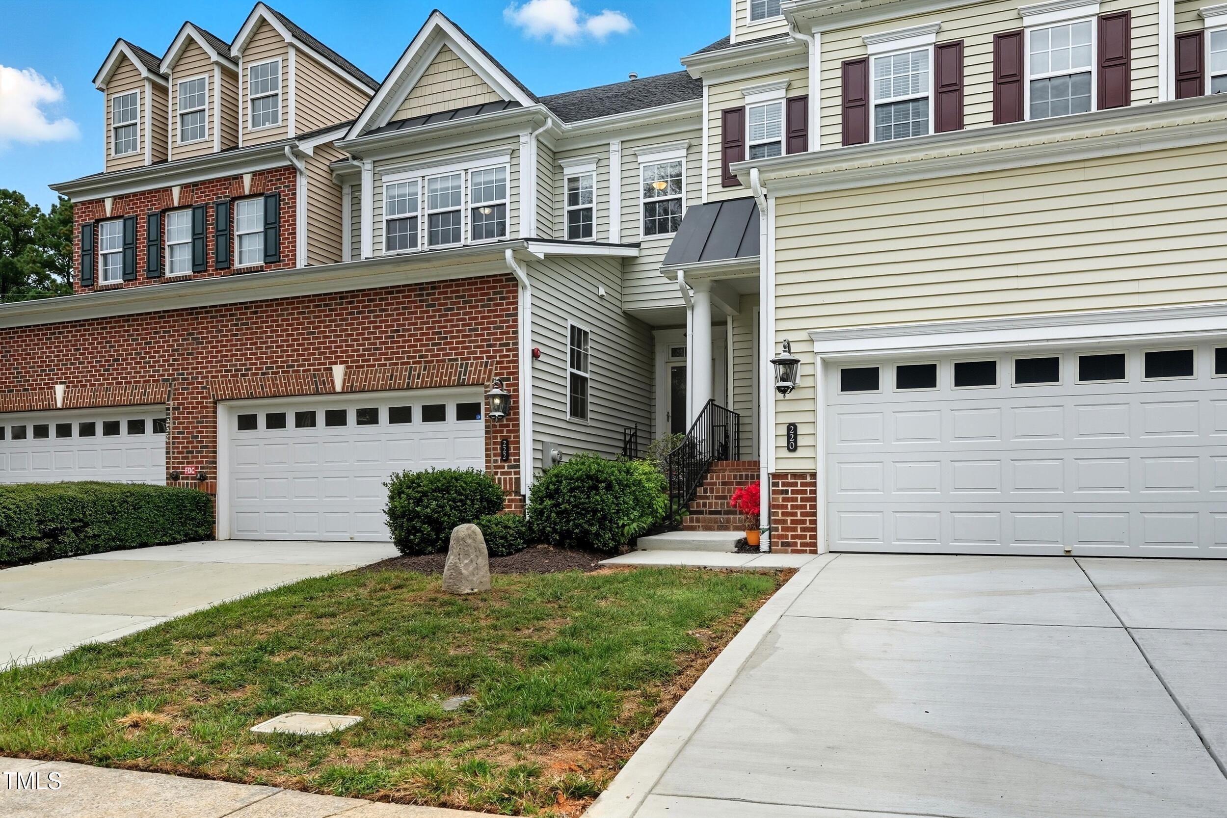222 Towne Ridge Lane Chapel Hill, NC 27516 - Photo 4 of 39 a front view of a building with a yard