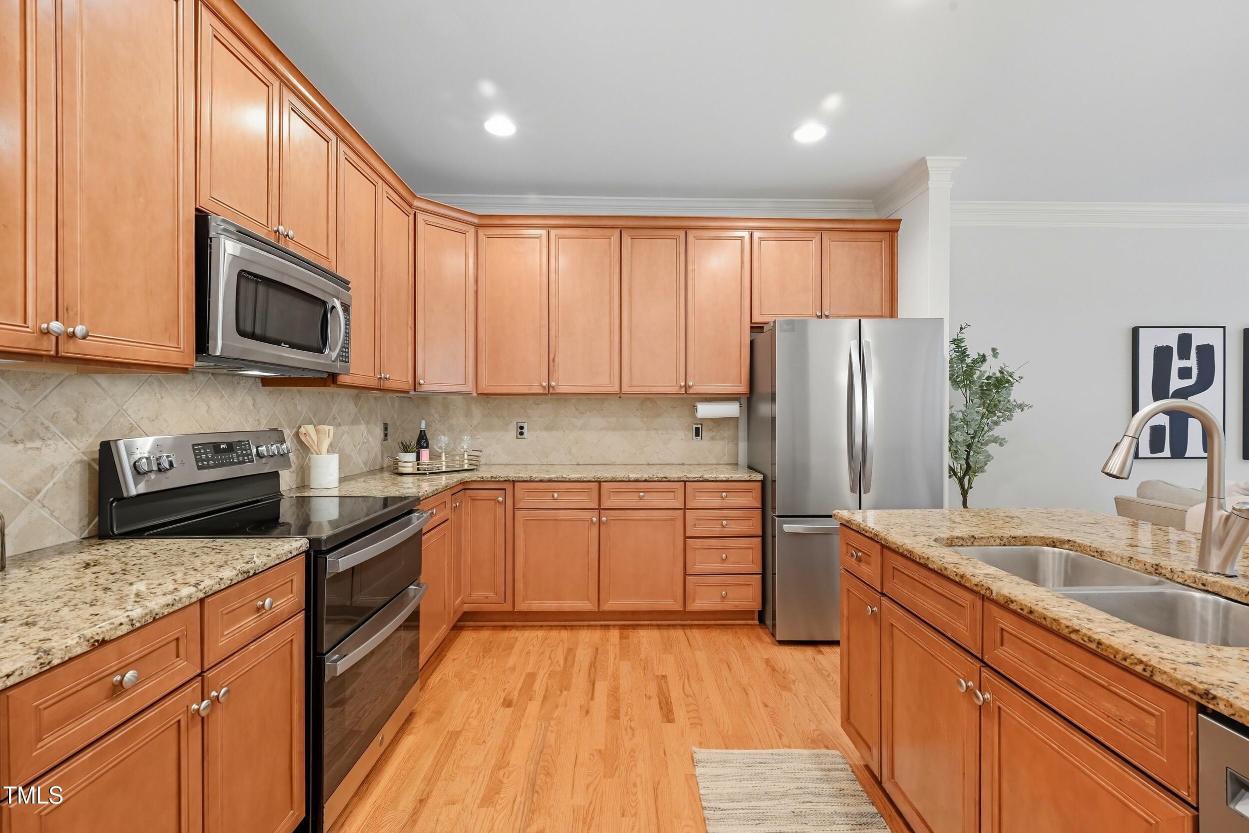222 Towne Ridge Lane Chapel Hill, NC 27516 - Photo 10 of 39 a kitchen with stainless steel appliances granite countertop a refrigerator stove microwave sink and cabinets