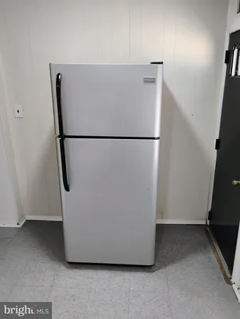 a white refrigerator freezer and a dishwasher sitting in a kitchen