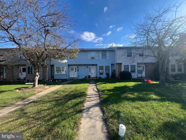 a house view with a sitting space and garden