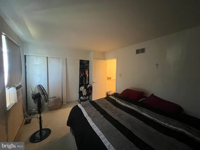 a bed room with a bed and a window