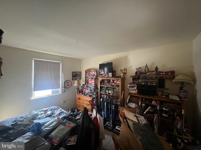 a bed sitting in a bedroom next to a window and storage