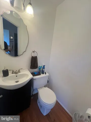 a bathroom with a sink toilet and mirror