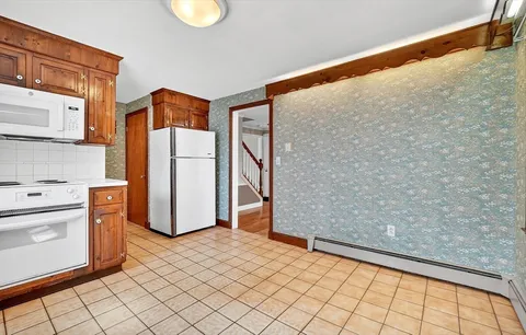 a kitchen with stainless steel appliances a refrigerator and a stove
