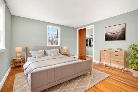 a bedroom with a bed and flat screen tv