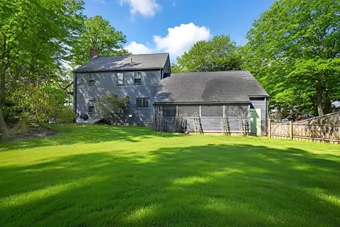 a house view with a garden space and backyard