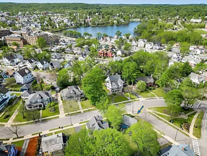 an aerial view of residential house with outdoor space and lake view