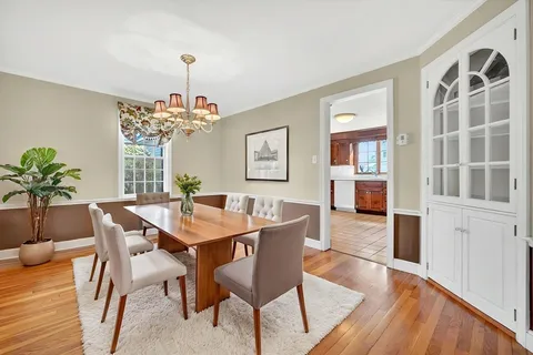 a view of a dining room with furniture and chandelier