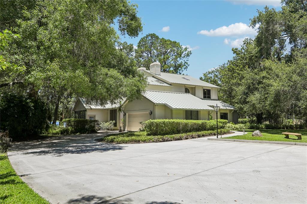 17810 Crawley Road Odessa, FL 33556 - Photo 64 of 76 a front view of a house with a yard and potted plants