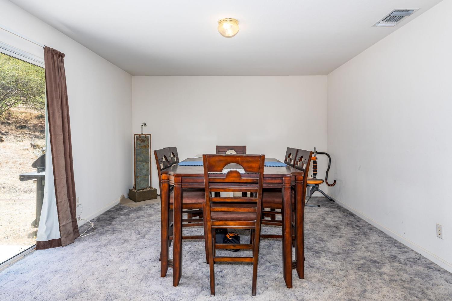 43142 Ellen Mine Road Coarsegold, CA 93614 - Photo 12 of 29 a view of a dining room with furniture and a window