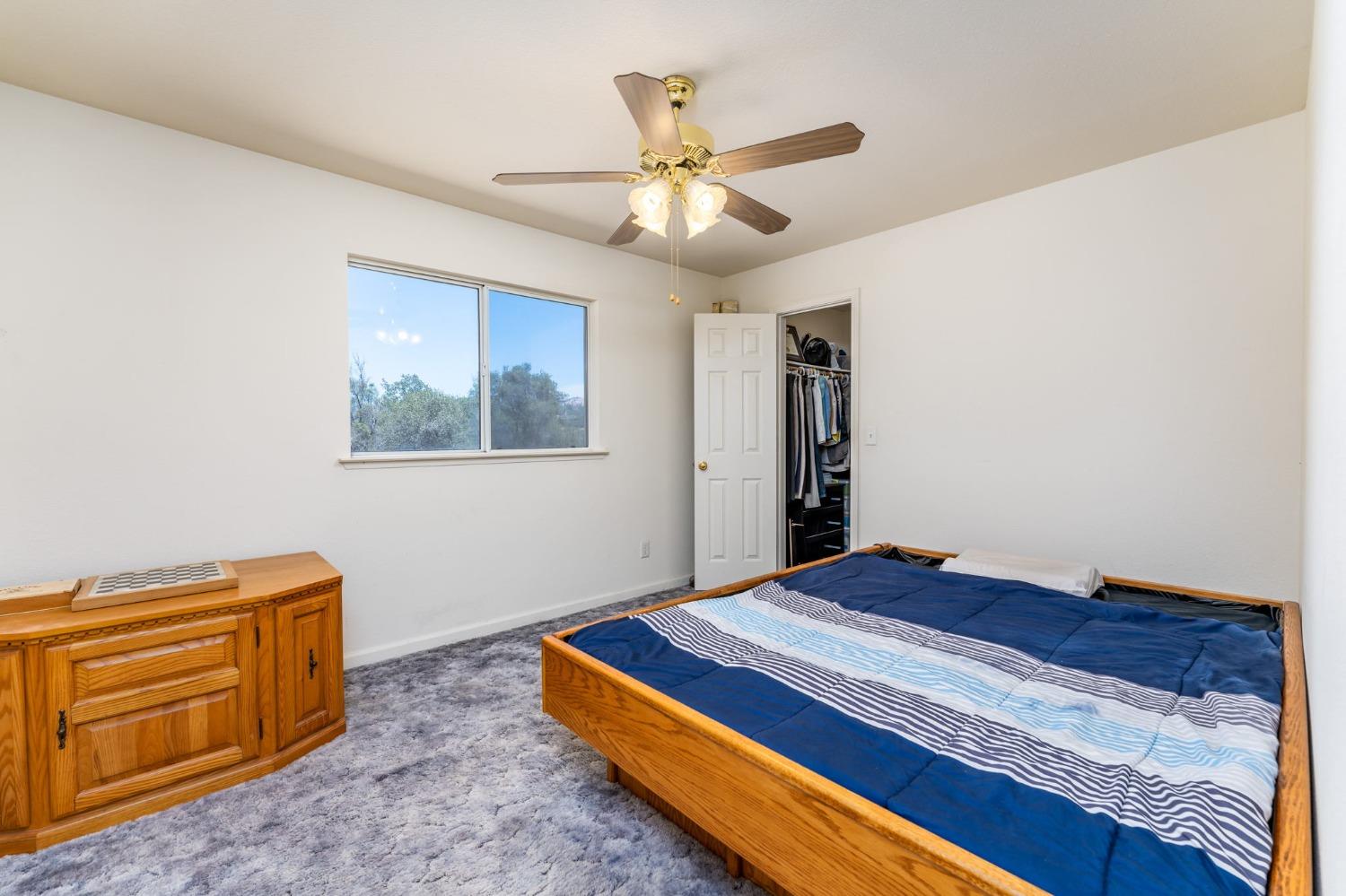 43142 Ellen Mine Road Coarsegold, CA 93614 - Photo 20 of 29 a bedroom with a bed and cabinet