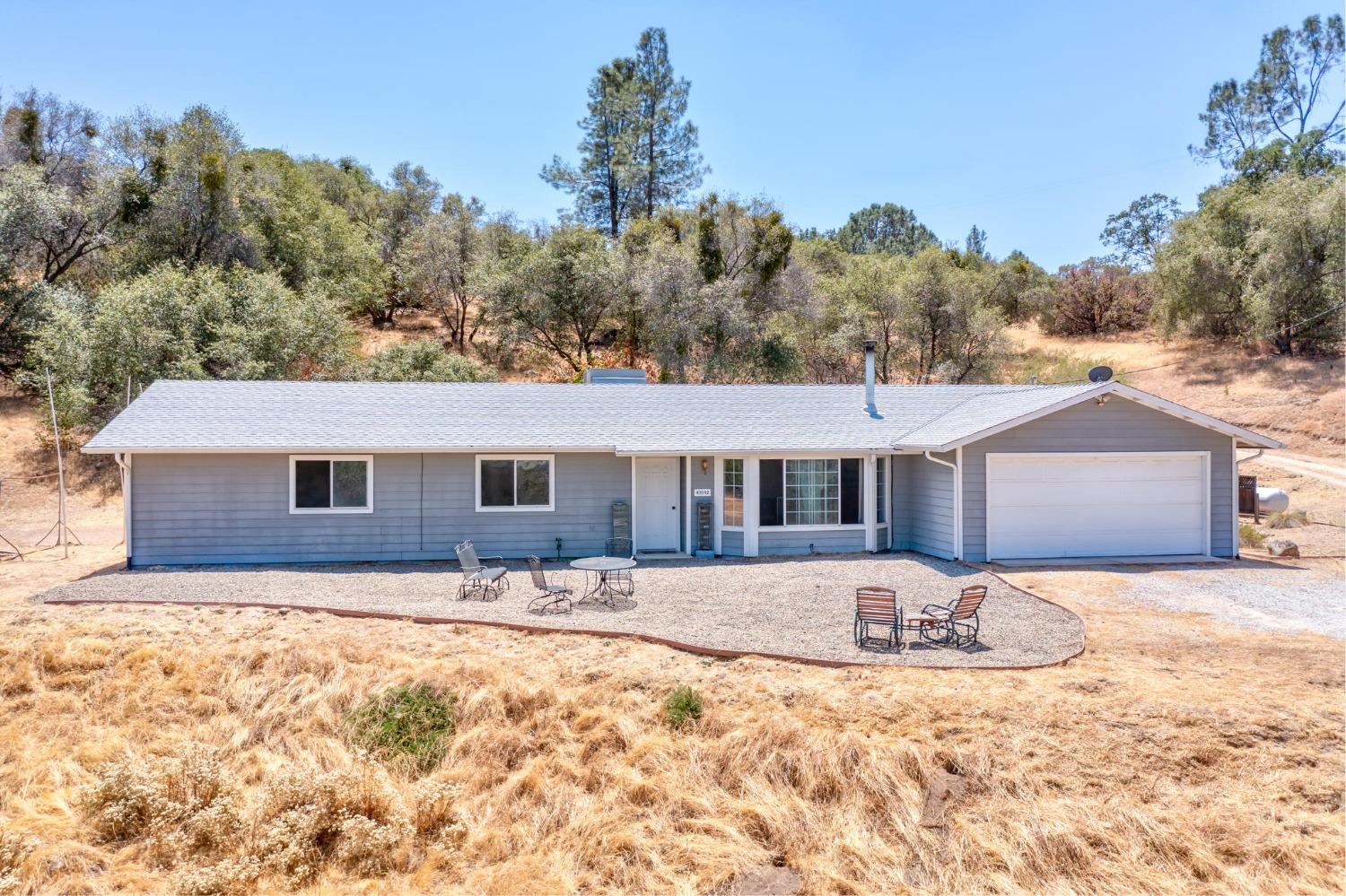 43142 Ellen Mine Road Coarsegold, CA 93614 - Photo 2 of 29 a front view of a house with a yard covered in snow