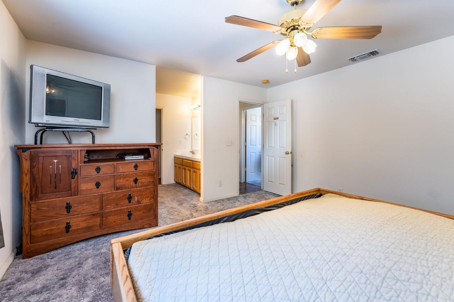 43142 Ellen Mine Road Coarsegold, CA 93614 - Photo 22 of 29 a bedroom with a bed and a flat screen tv