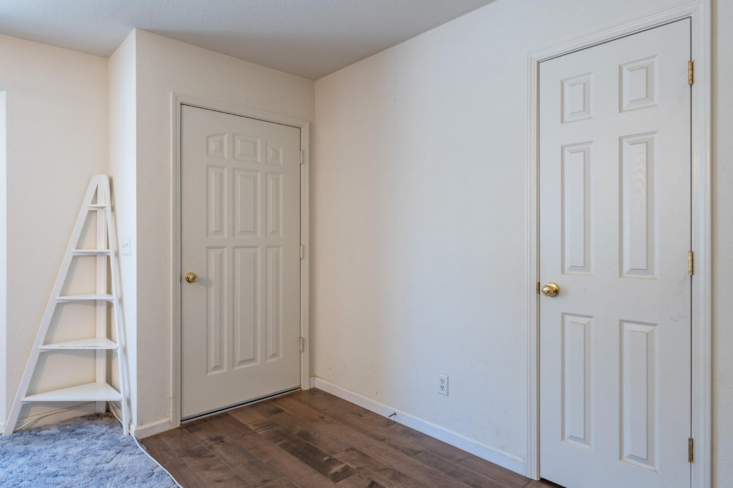 43142 Ellen Mine Road Coarsegold, CA 93614 - Photo 7 of 29 an empty room with wooden floor closet and windows