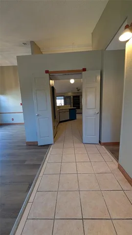 a view of a livingroom with an empty space and a window