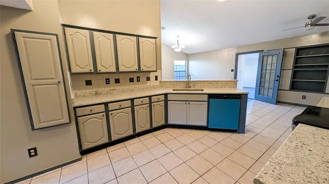 a large kitchen with a sink window and stainless steel appliances