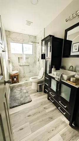a kitchen with kitchen island granite countertop a sink stove and refrigerator