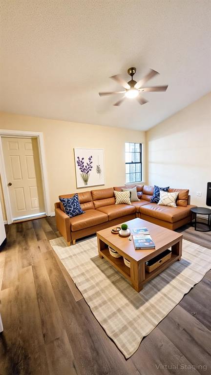 2204 Crestmeadow Street Denton, TX 76207 - Photo 7 of 21 a living room with furniture a rug and a ceiling fan