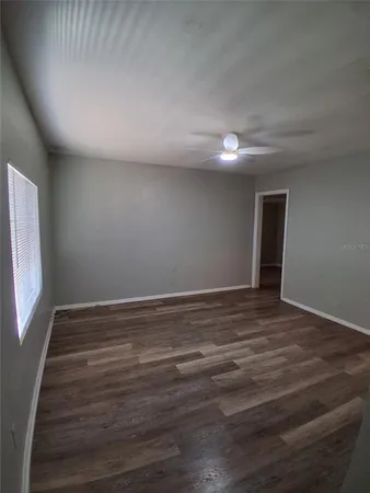 a view of room with window and hardwood floor