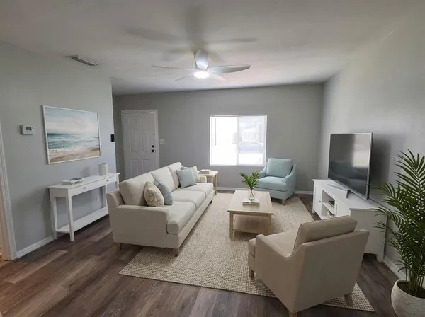 a living room with furniture and a flat screen tv