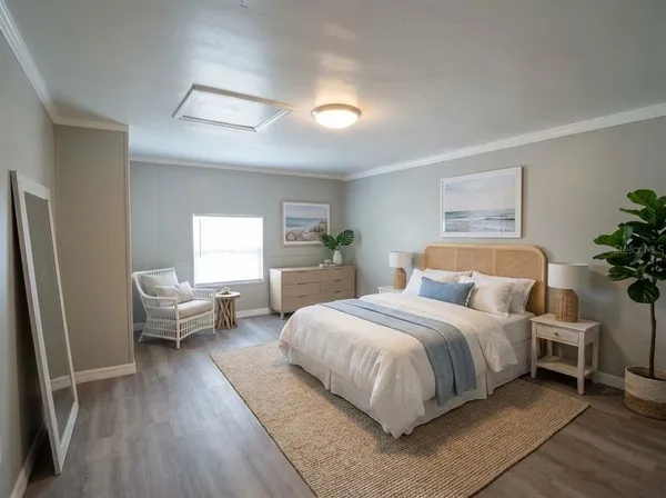 a bedroom with a bed and wooden floor