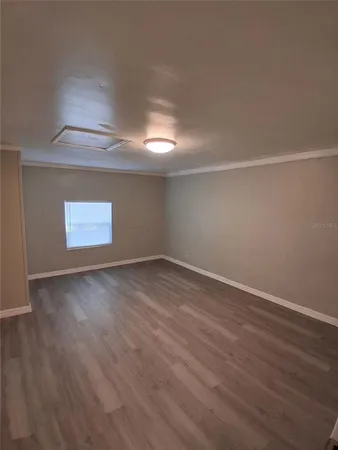 a view of an empty room and wooden floor
