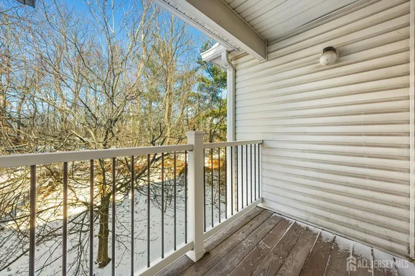 a view of a balcony with wooden floor