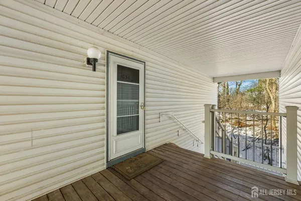 a view of front door and deck of the house
