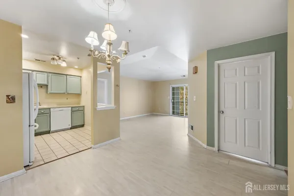 a view of a kitchen with a cabinet and a chandelier
