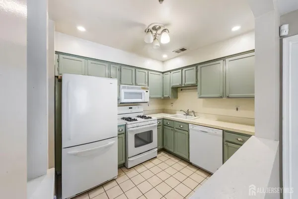 a kitchen with stainless steel appliances white cabinets and a sink