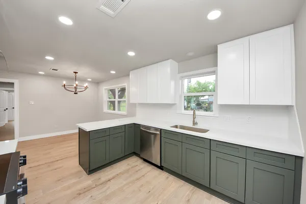 a kitchen with sink and cabinets