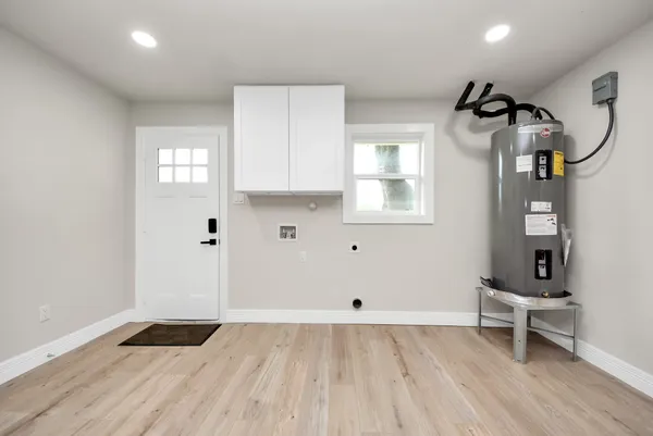a view of a livingroom with wooden floor and a window