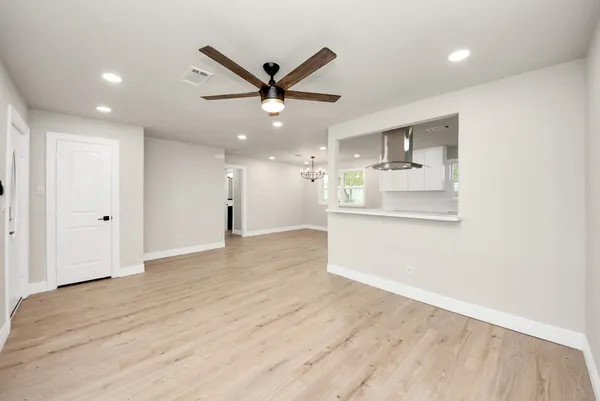 a view of a kitchen with a dishwasher and wooden floor