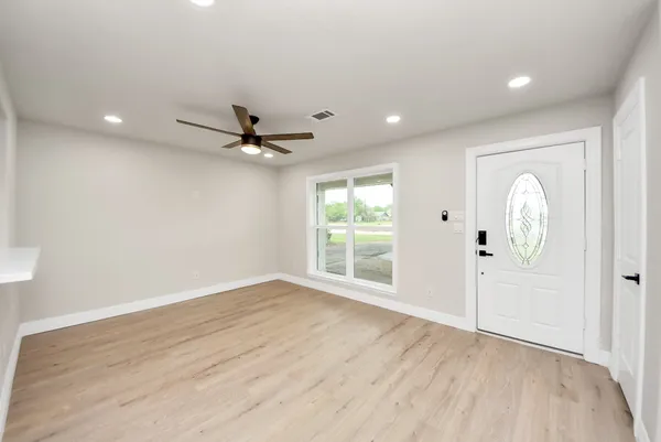 wooden floor in an empty room with a window